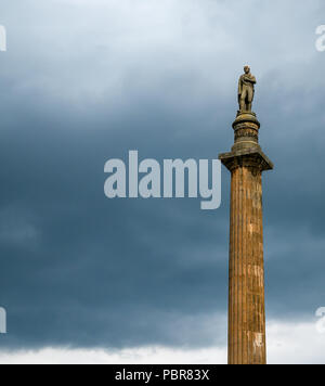 Sir Walter Scott Memorial Column statue and with stormy threatening dark sky, George Square, Glasgow, Scotland, UK Stock Photo