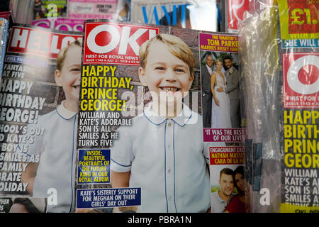 Prince George 5th birthday smiling on the front cover of OK magazine and magazines on a newsagent shelf at WH Smith store in London UK  KATHY DEWITT Stock Photo