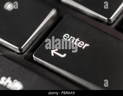 Macro view of black laptop keyboard enter button Stock Photo