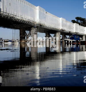 AJAXNETPHOTO. BURSLEDON, ENGLAND. - BRIDGE REPAIRS -THE RAILWAY BRIDGE OVER THE RIVER HAMBLE AT BURSLEDON SHRINK WRAPPED FOR A MAJOR REFIT AND REPAINTING. THE BRIDGE IS EXPECTED TO BE UNVEILED IN MARCH 2006.  PHOTO:JONATHAN EASTLAND/AJAX REF:V51011/529 Stock Photo