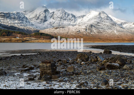 Bla Bheinn or to give it its anglicised name, Blaven, seen here across Loch Slapin. This image captured early morning in February just after the snow. Stock Photo