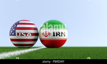 USA vs. Iran Soccer Match - Soccer balls in USA and Iran national colors on a soccer field. Copy space on the right side - 3D Rendering Stock Photo