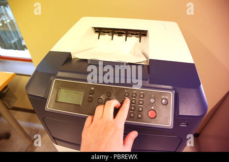 Close-up of a business assistant using a printer Stock Photo