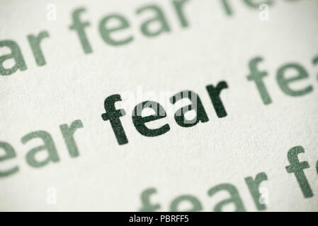 word fear printed on white paper macro Stock Photo