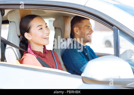 Positive nice couple sitting in the car Stock Photo