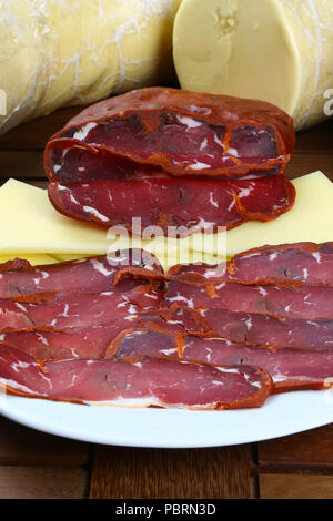 Pastirami / Pastourmás / Pastrama / Slices dried beef coated spices on white ware Stock Photo
