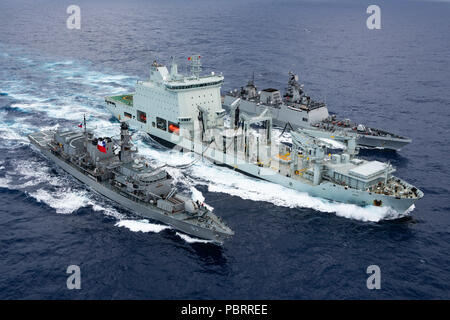180728-N-CW570-1105 PACIFIC OCEAN (July 28, 2018)  Chilean Navy frigate CNS Almirante Lynch (FF 07) and Indian Navy stealth multi-role frigate INS Sahyadri (F49) performs a replenishment-at-sea with Royal Canadian Navy supply ship MV Asterix off the coast of Hawaii during Rim of the Pacific (RIMPAC) exercise, July 28. Twenty-five nations, 46 ships, five submarines, and about 200 aircraft and 25,000 personnel are participating in RIMPAC from June 27 to Aug. 2 in and around the Hawaiian Islands and Southern California. The world’s largest international maritime exercise, RIMPAC provides a unique Stock Photo