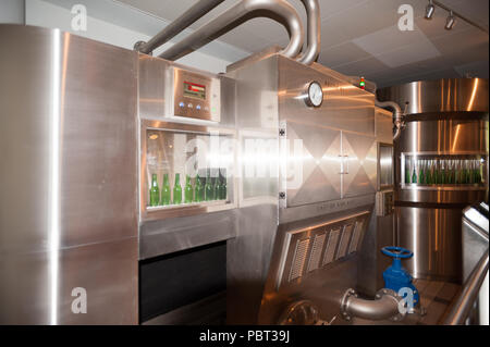 AMSTERDAM, NETHERLANDS - JUN 3, 2015: Bottles of Heineken at the Heineken Experience center, a historic brewery for Heineken beer. Gerard Adriaan Hein Stock Photo