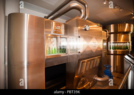 AMSTERDAM, NETHERLANDS - JUN 3, 2015: Bottles of Heineken at the Heineken Experience center, a historic brewery for Heineken beer. Gerard Adriaan Hein Stock Photo