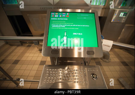 AMSTERDAM, NETHERLANDS - JUN 3, 2015: Bottles of Heineken at the Heineken Experience center, a historic brewery for Heineken beer. Gerard Adriaan Hein Stock Photo