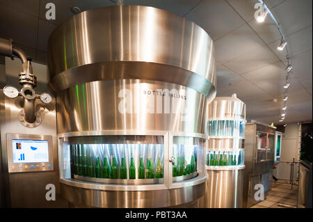 AMSTERDAM, NETHERLANDS - JUN 3, 2015: Bottles of Heineken at the Heineken Experience center, a historic brewery for Heineken beer. Gerard Adriaan Hein Stock Photo