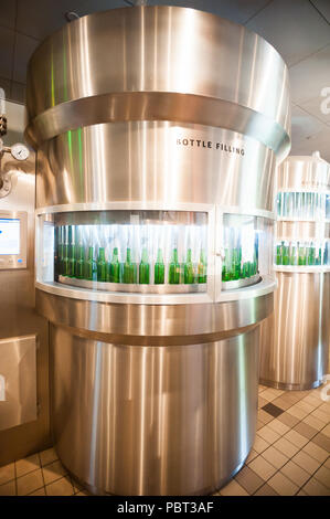 AMSTERDAM, NETHERLANDS - JUN 3, 2015: Bottles of Heineken at the Heineken Experience center, a historic brewery for Heineken beer. Gerard Adriaan Hein Stock Photo