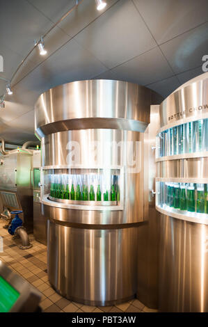 AMSTERDAM, NETHERLANDS - JUN 3, 2015: Bottles of Heineken at the Heineken Experience center, a historic brewery for Heineken beer. Gerard Adriaan Hein Stock Photo