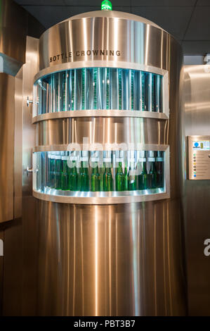 AMSTERDAM, NETHERLANDS - JUN 3, 2015: Bottles of Heineken at the Heineken Experience center, a historic brewery for Heineken beer. Gerard Adriaan Hein Stock Photo