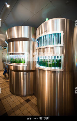 AMSTERDAM, NETHERLANDS - JUN 3, 2015: Bottles of Heineken at the Heineken Experience center, a historic brewery for Heineken beer. Gerard Adriaan Hein Stock Photo