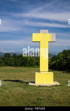 Large concrete cross, monument to the fallen in the Spanish Civil War, painted yellow which is the colour symbolising Catalonian independence, Olot, C Stock Photo