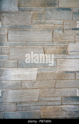 Gray and brown concrete or stone wall on a building Stock Photo