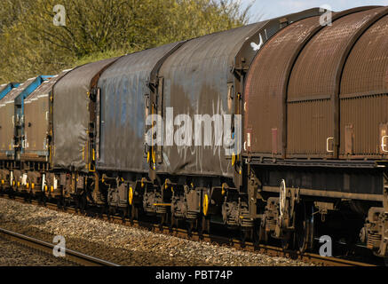 Close up view of part of a long and heavy rail freight train of wagons Stock Photo