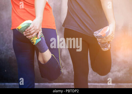 Two women who were warming up before running. Stock Photo