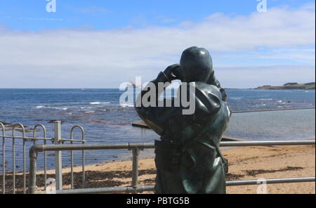 The Watcher by Kenny Hunter bronze sculpture and Bass Rock North Berwick Scotland  July 2018 Stock Photo