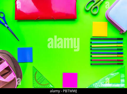 School accessories, pencils, paints, pens on green background. Back to school. Flat lay, top view, copy space Stock Photo