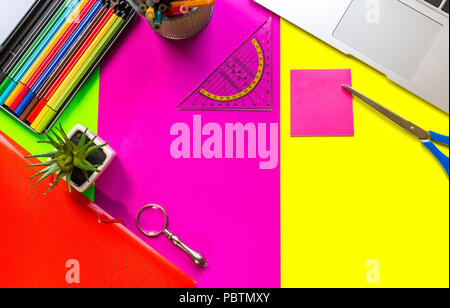 Flat lay, top view office table desk frame. feminine desk workspace with office accessories including Magnifying glass, cutter, sticky notes and penci Stock Photo