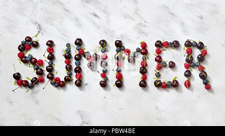 Summer background with summer berries - word "SUMMER" from cherry, raspberry, blueberries on gray stone background. Stock Photo