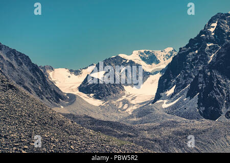 Mountains with snow caps in a dark tinting. Altai mountains Siberia Russia Stock Photo