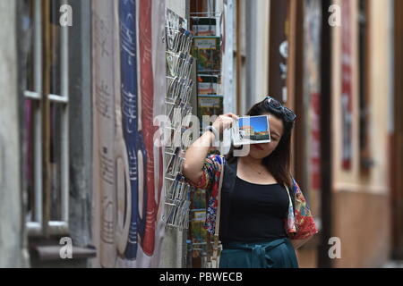 The Czechoslovak pavilion at the architecture exhibition in Venice (La Binnale di Venezia) shows the life in a town full of tourists, the UNESCO-listed Cesky Krumlov, south Bohemia, within a project of Czech artist Katerina Seda. During six months of the 16th International Biennale of Architecture in Venice 2018, the pavilion will turn into the seat of the fictitious firm UNES-CO, (which means KIDNAP-WHAT in Czech). Along with several volunteers, it is trying to bring normal life into Ceske Krumlov, which is exploited by tourism. The firm made up by Seda therefore employs people only to carry Stock Photo