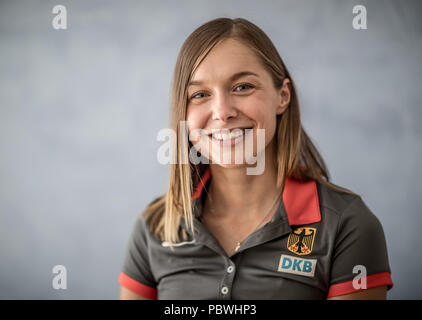 30 July 2018, Germany, Gruenheide, Kienbaum, summer party at the training centre, press conference German Athletics Association: Gina Lueckenkemper, 100 meter sprinter of the German Athletics Association (DLV), smiles during the photocall. Photo: Michael Kappeler/dpa Stock Photo