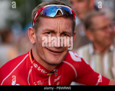 Hanover, Germany. 30th July, 2018. 30.07.2018, Lower Saxony, Hanover: Cycling: Professional cyclist Andre Greipel, Team Lotto-Soudal, smiles before the 'Die Nacht' race about 850 meters long circuit in front of the New Town Hall in Hanover. Credit: Peter Steffen/dpa/Alamy Live News Stock Photo