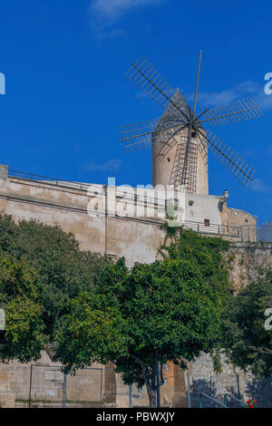 view of a mill on a fortification wall in the ancient Spanish city of Palma de Mallorca against a blue sky Stock Photo