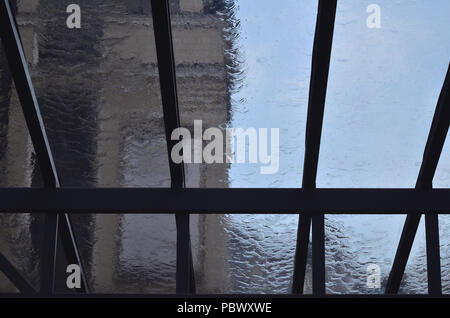 A heavy rain is pouring through the window in the daytime Stock Photo