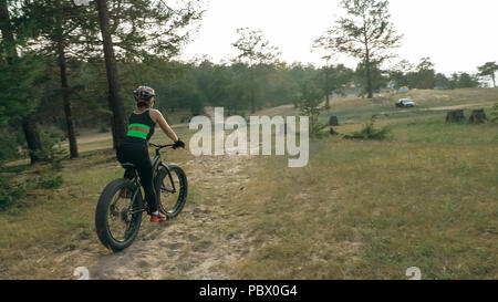 Fat bike also called fatbike or fat-tire bike in summer riding in the forest. Stock Photo