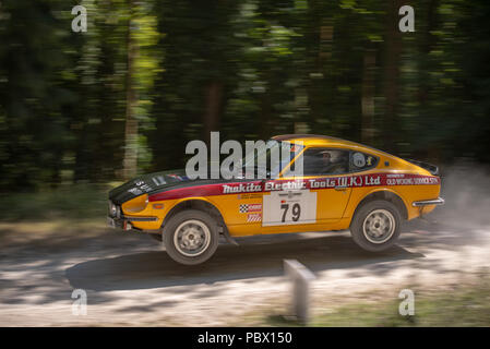 A Datsun 240Z Monte Carlo rally car takes off from the jump in the forest rally stages at the Goodwood Festival of Speed 2018 Stock Photo