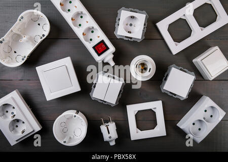 white electrical equipment on wooden background. top view Stock Photo