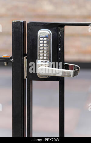 Electronic lock with pin code at fence Stock Photo