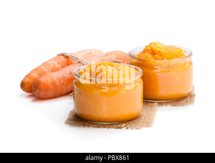 Carrot  puree in glass jars isolated on white Stock Photo