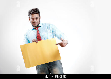 happy Young indian man showing blank poster Stock Photo