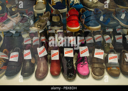 Children's shoes on sale in a shop window in Honfleur, France Stock Photo