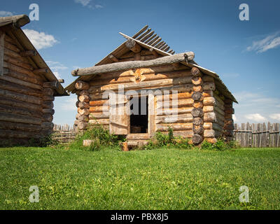 Ancient log house in a country side in a sunny day Stock Photo