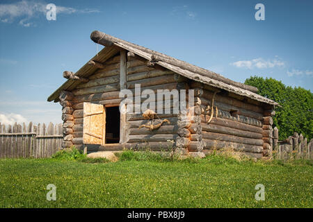 Ancient log house in a country side in a sunny day Stock Photo