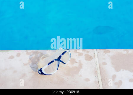 Goggles at swimming pool Stock Photo