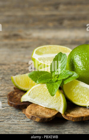 Fresh citrus lime mint berries on wooden background. Copy space for text Stock Photo