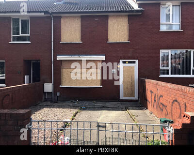 The boarded up house of a grieving mother who was ordered from her Belfast home by loyalist paramilitaries as she waited to bring her son's body home. Stock Photo