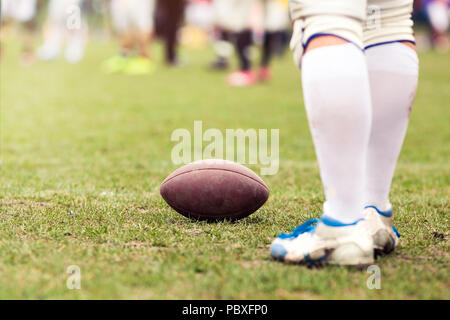 american football on the field - defocused players in the background Stock Photo