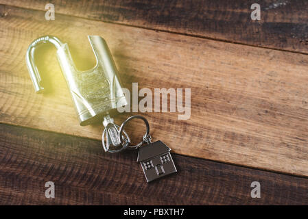 lock, key and house shape key tag on wooden table. house security and privacy concept Stock Photo