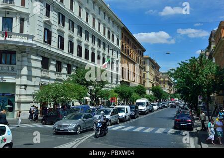 Passenger Cars waiting for the traffic light to go Green on a busy afternoon. Commercial and Residential Buildings near street, Rome, Italy, Europe Stock Photo