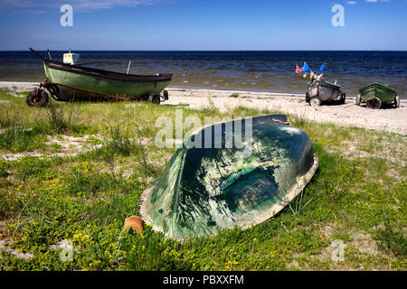 Fishing boats with the numbers on the grass in the sand dunes of the Baltic Sea on a sunny summer day Stock Photo