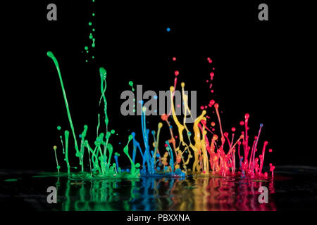 Abstract sculptures of colorful splashes of paint. Dancing liquid on a black background. Ink water splash. Color explosion. Stock Photo